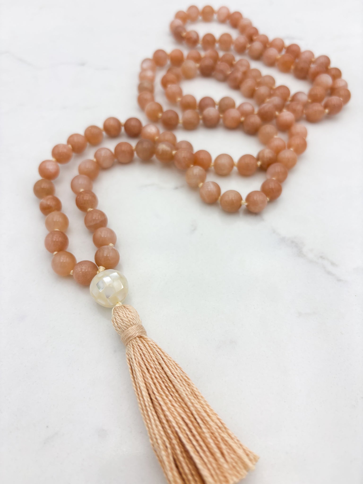 peach moonstone gemstone mala with mother of pearl guru bead and peach tassel | radiant malas | handmade in boulder, colorado