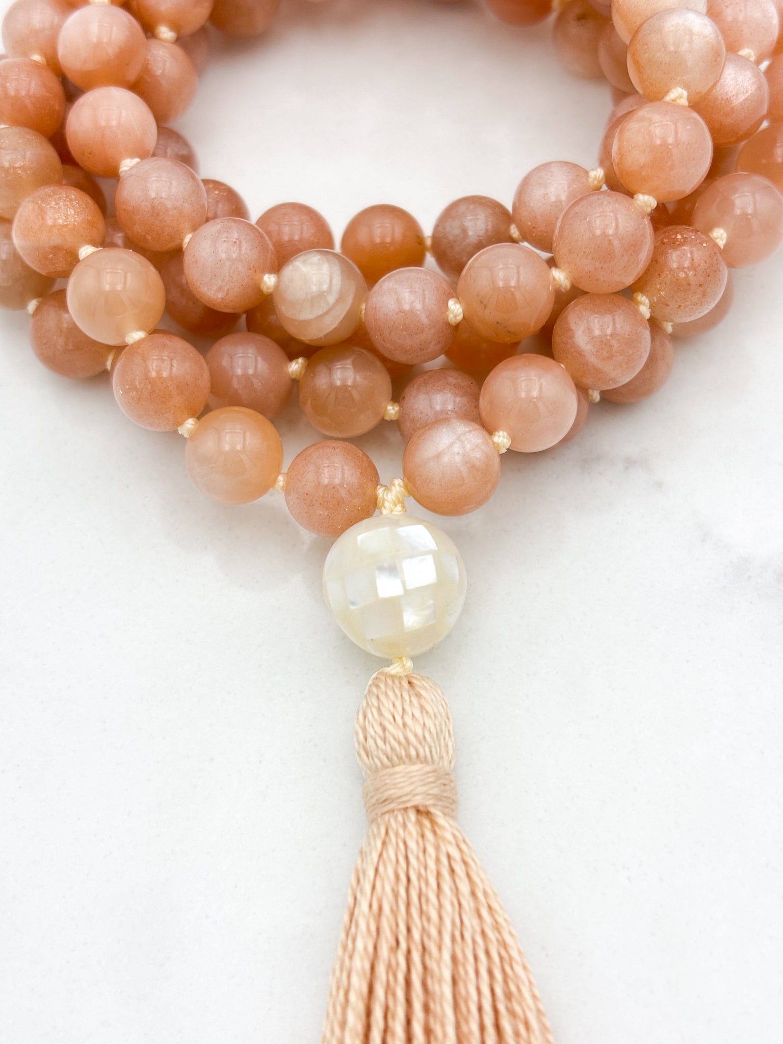 peach moonstone gemstone mala with mother of pearl guru bead and peach tassel | radiant malas | handmade in boulder, colorado