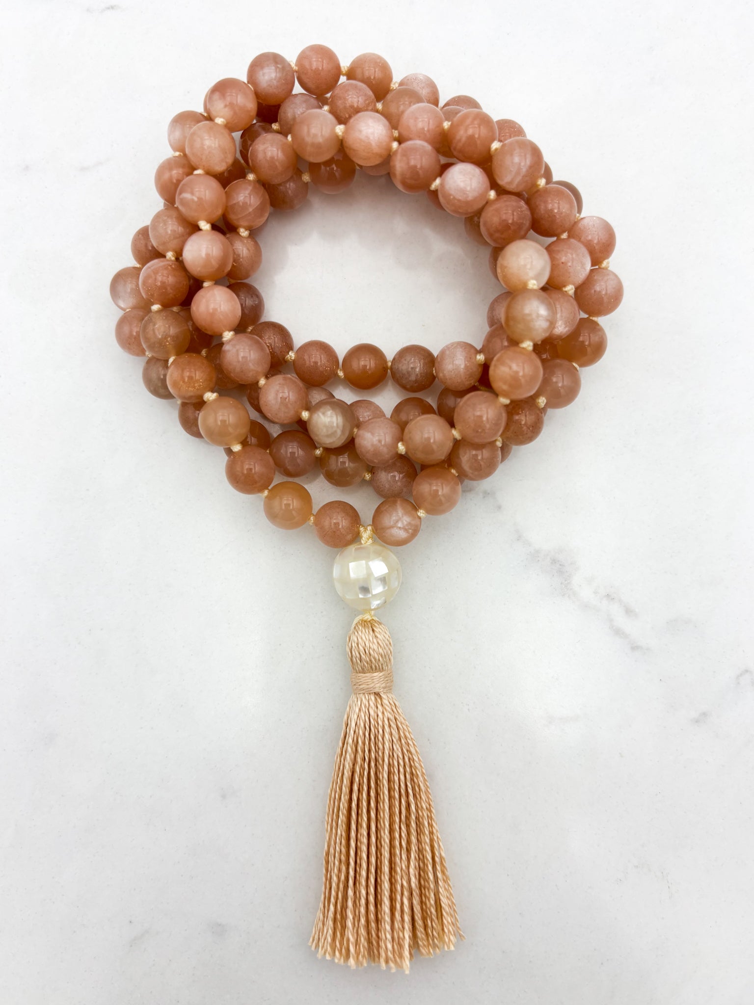 peach moonstone gemstone mala with mother of pearl guru bead and peach tassel | radiant malas | handmade in boulder, colorado