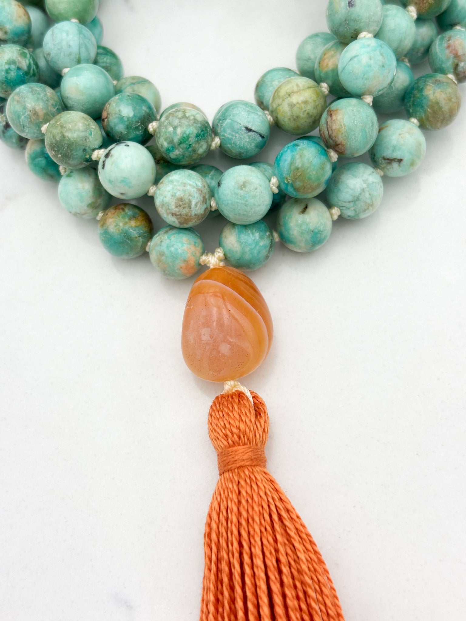 Peruvian Turquoise mala necklace with botswana agate guru bead and orange tassel | radiant malas | handmade in boulder, colorado