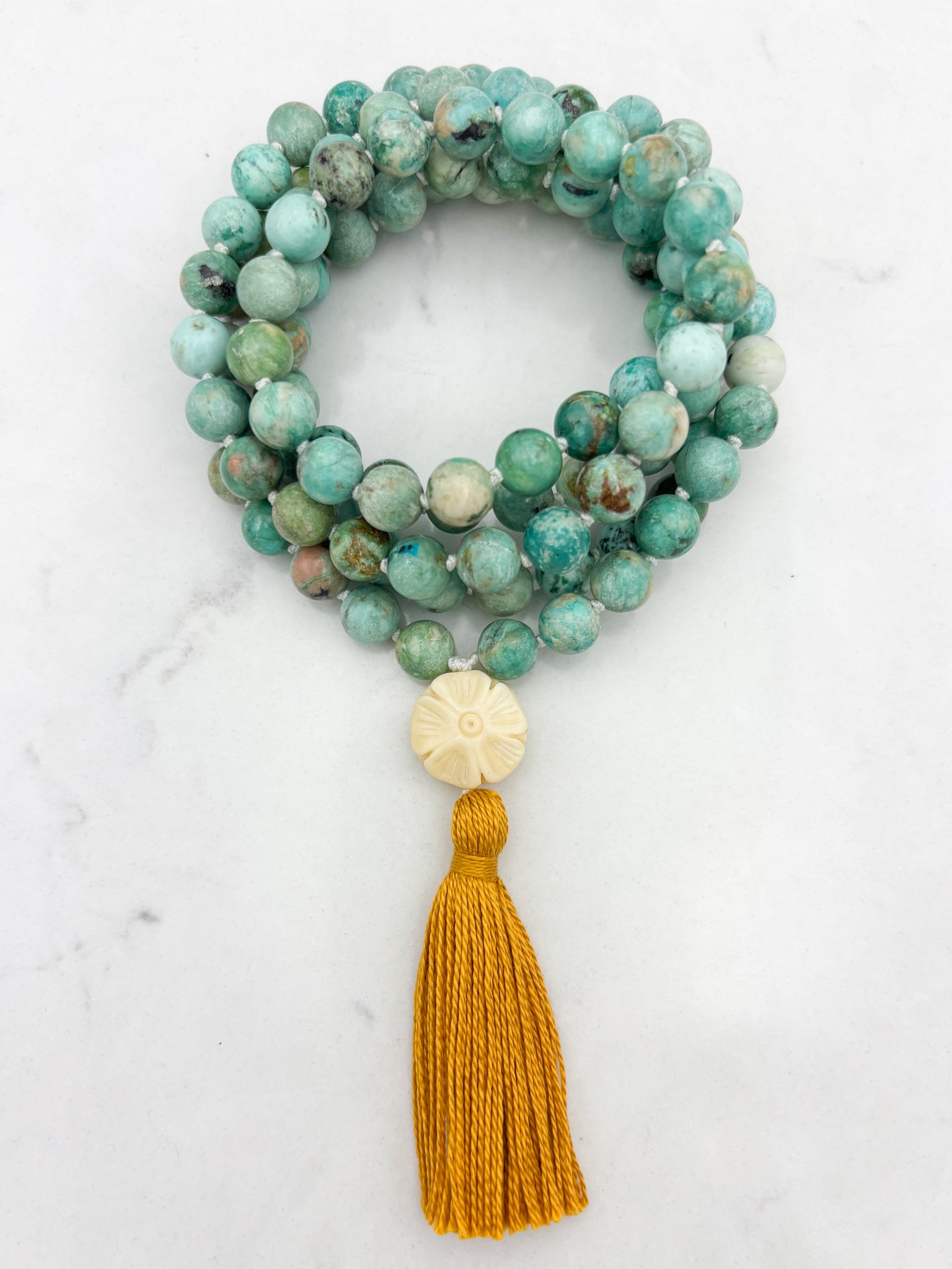 Peruvian Turquoise mala necklace with bone flower-carved guru bead and gold tassel | radiant malas | handmade in boulder, colorado