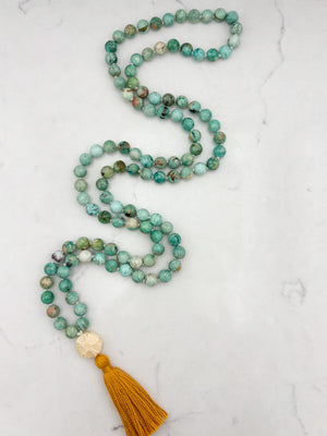 Peruvian Turquoise mala necklace with bone flower-carved guru bead and gold tassel | radiant malas | handmade in boulder, colorado
