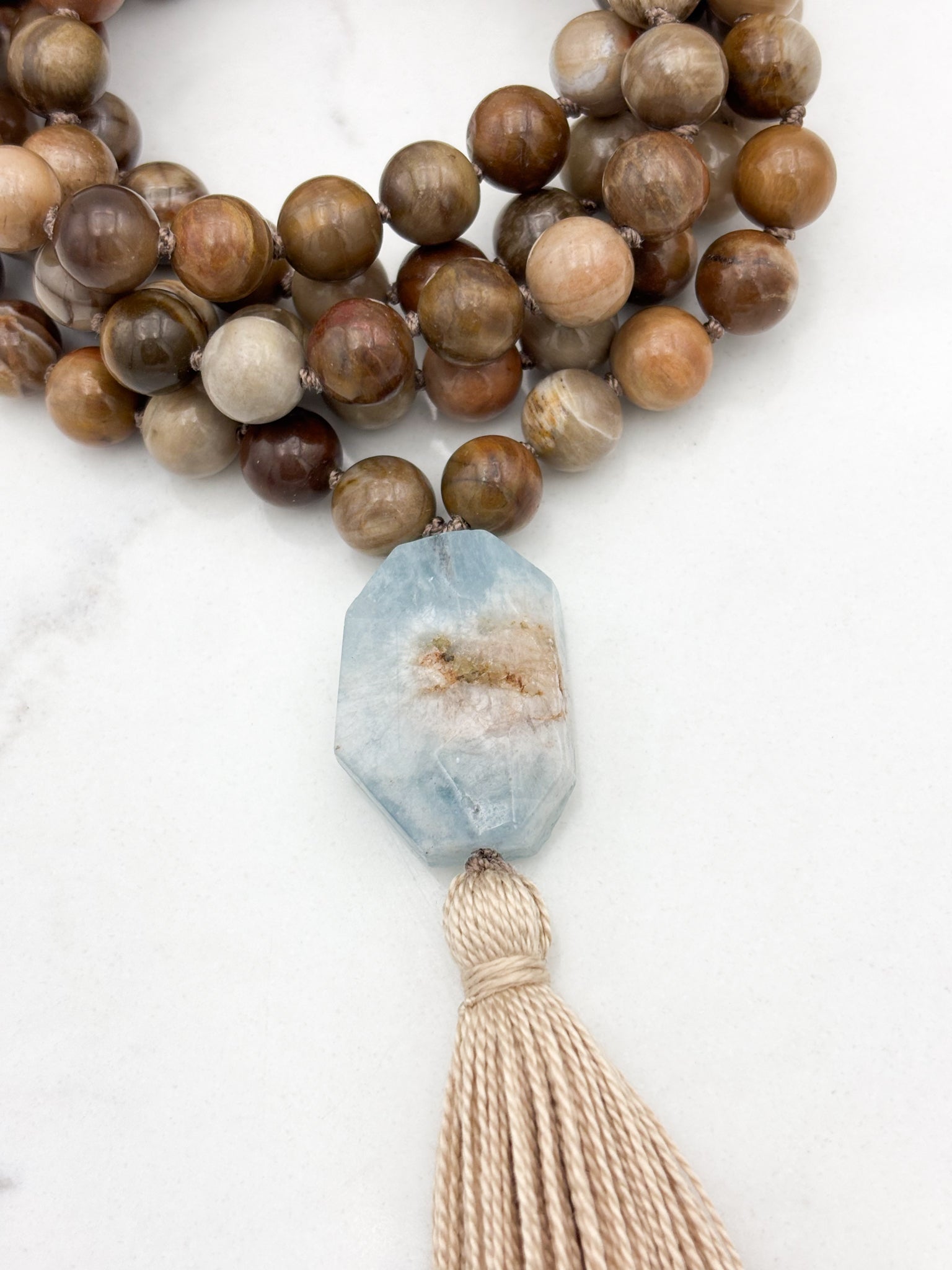 petrified wood gemstone mala with aquamarine guru bead and tan tassel | radiant malas | handmade in boulder colorado