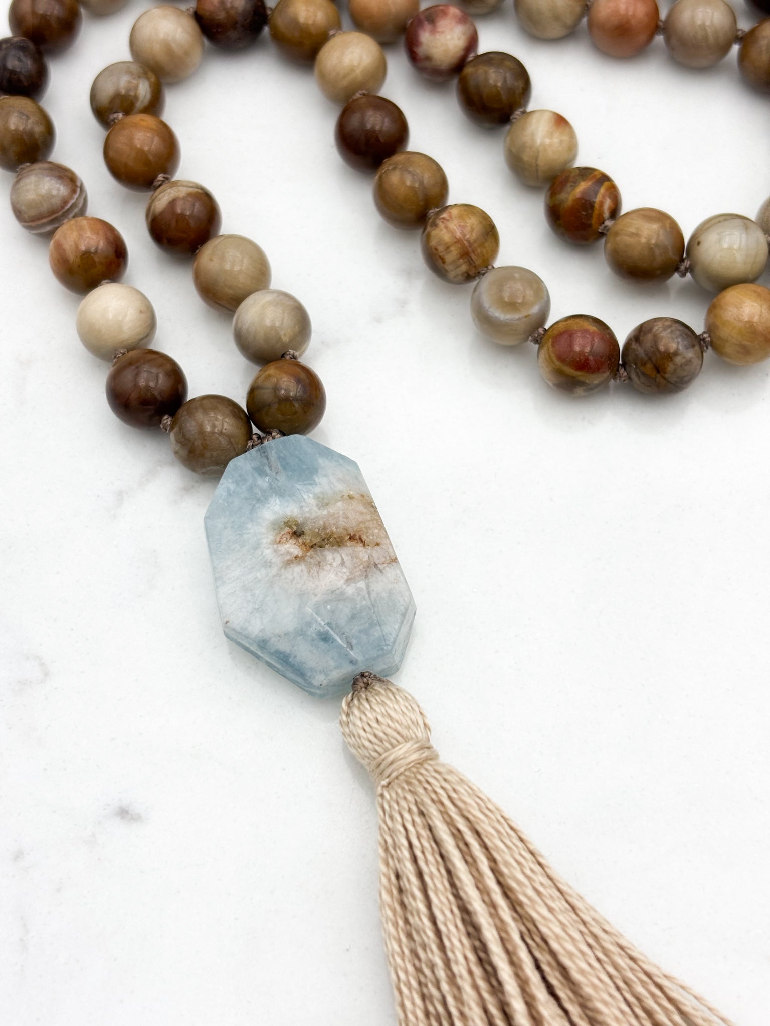 petrified wood gemstone mala with aquamarine guru bead and tan tassel | radiant malas | handmade in boulder colorado