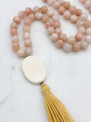 pink opal gemstone mala with oval bone guru bead and yellow colored tassel | radiant malas | handmade in boulder, colorado
