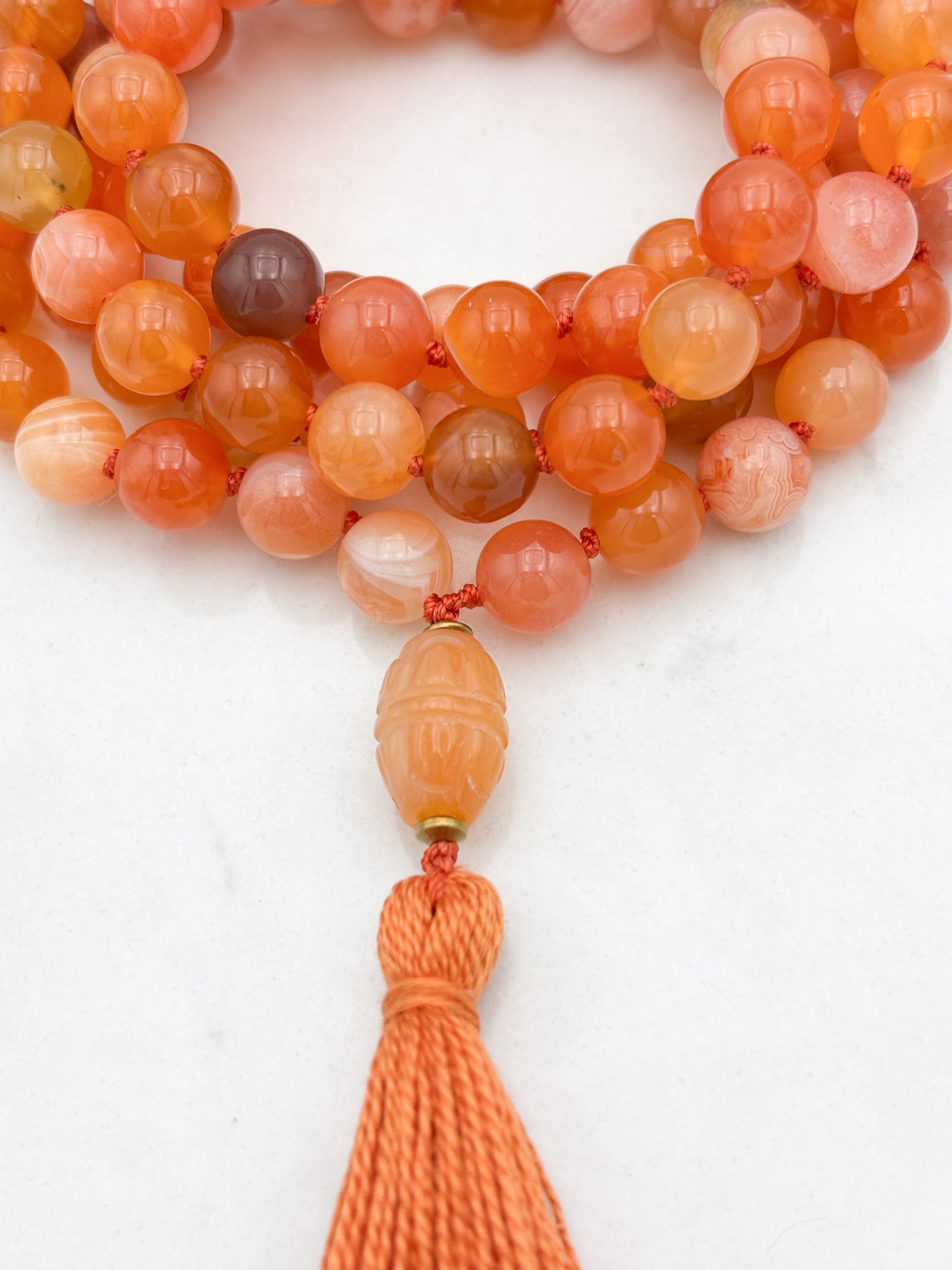 Red Botswana Agate Gemstone Mala with carved carnelain guru bead and orange tassel | radiant malas | handmade in Boulder, colorado