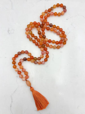 Red Botswana Agate Gemstone Mala with carved carnelain guru bead and orange tassel | radiant malas | handmade in Boulder, colorado
