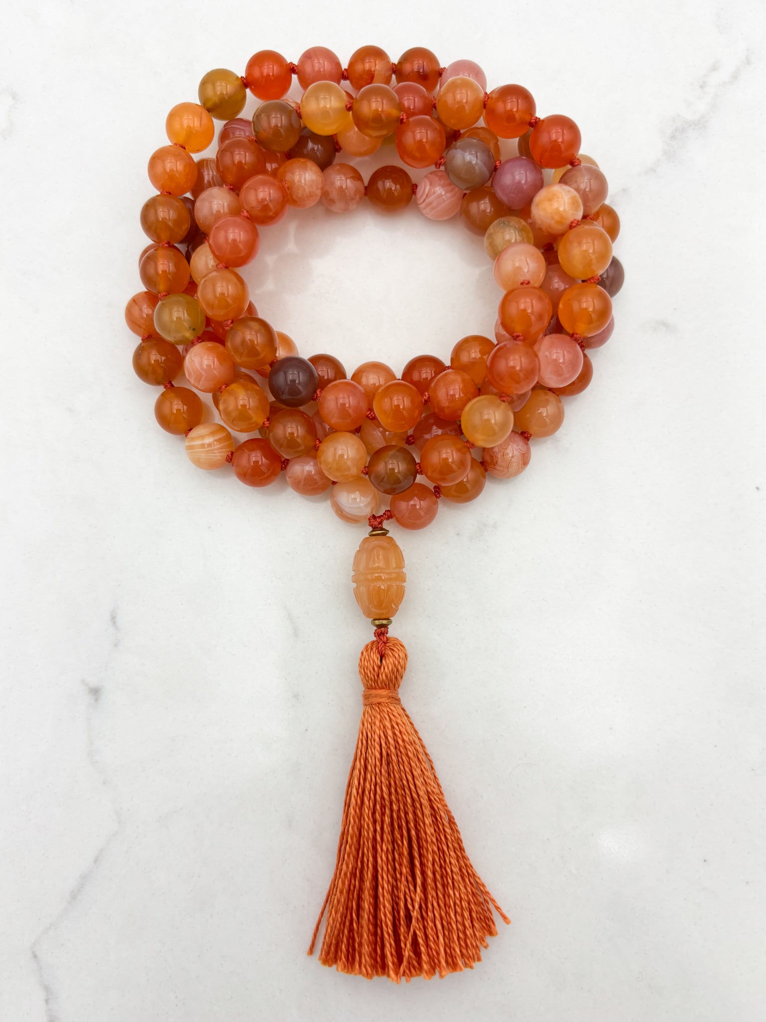 Red Botswana Agate Gemstone Mala with carved carnelain guru bead and orange tassel | radiant malas | handmade in Boulder, colorado