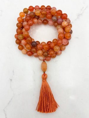 Red Botswana Agate Gemstone Mala with carved carnelain guru bead and orange tassel | radiant malas | handmade in Boulder, colorado