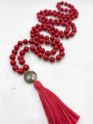 red coral gemstone mala necklace with faceted pyrite guru bead and red tassel | radiant malas | handmade in boulder, colorado