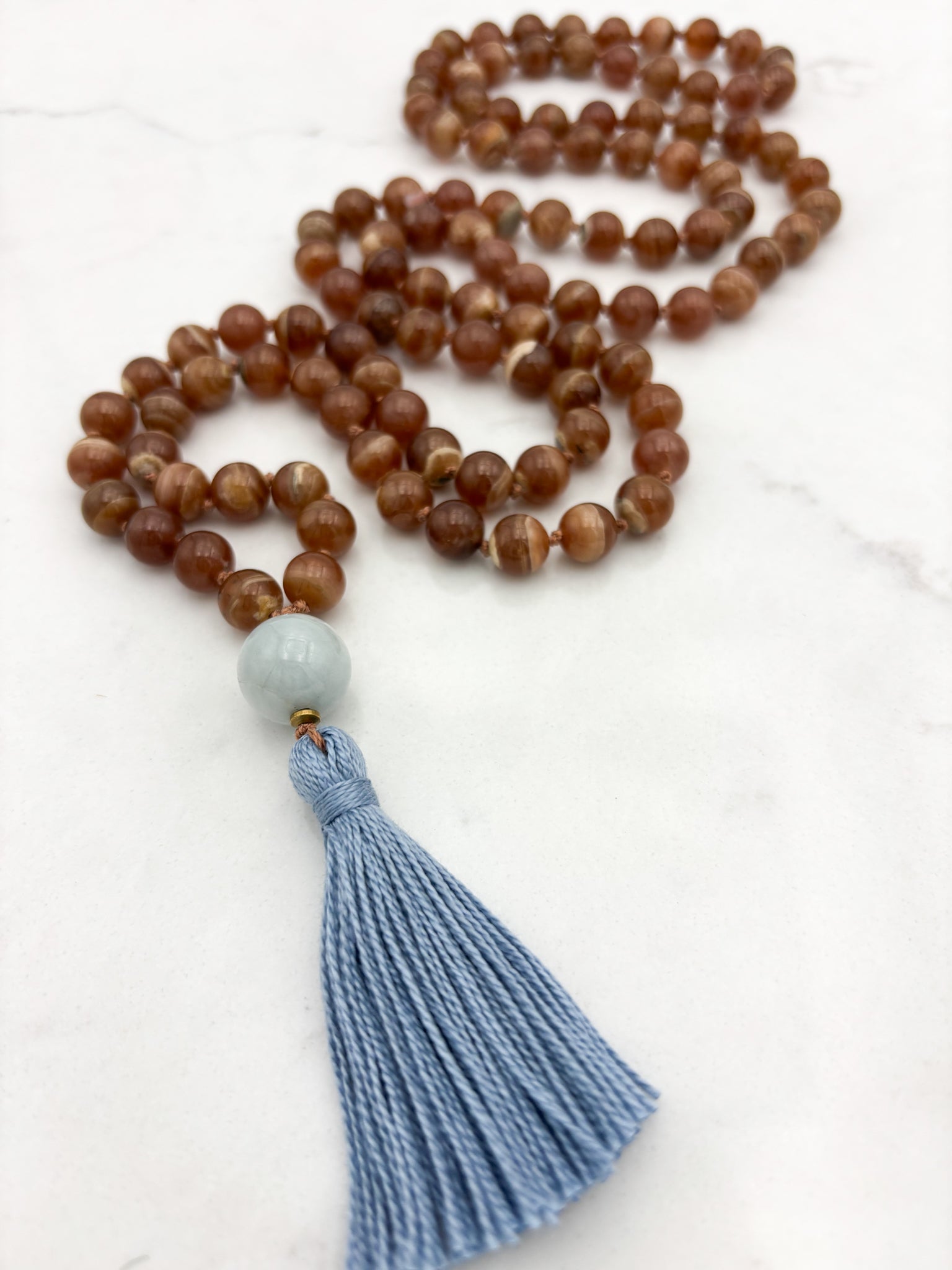 rhodochrosite gesmtone mala with burma jade guru bead and blue tassel | radiant malas | handmade in boulder, colorado