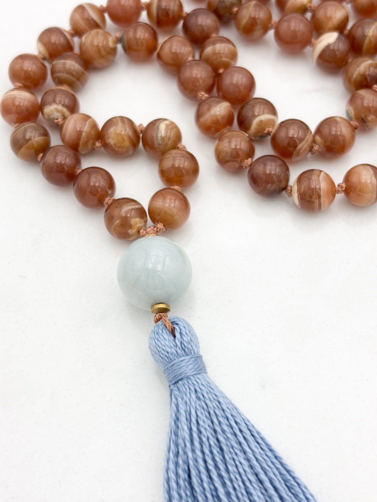rhodochrosite gesmtone mala with burma jade guru bead and blue tassel | radiant malas | handmade in boulder, colorado