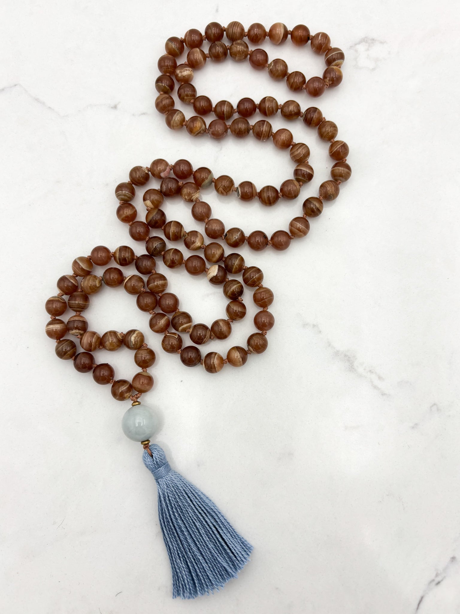 rhodochrosite gesmtone mala with burma jade guru bead and blue tassel | radiant malas | handmade in boulder, colorado