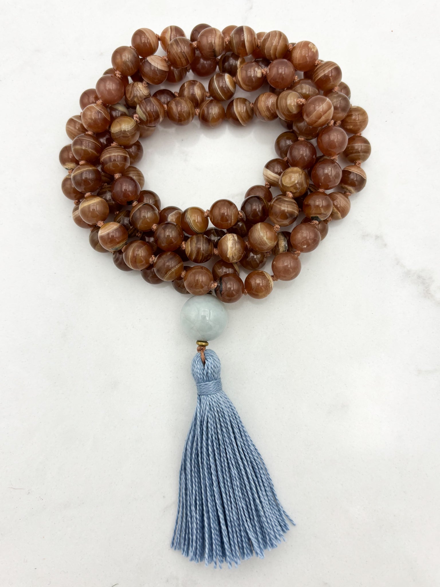 rhodochrosite gesmtone mala with burma jade guru bead and blue tassel | radiant malas | handmade in boulder, colorado