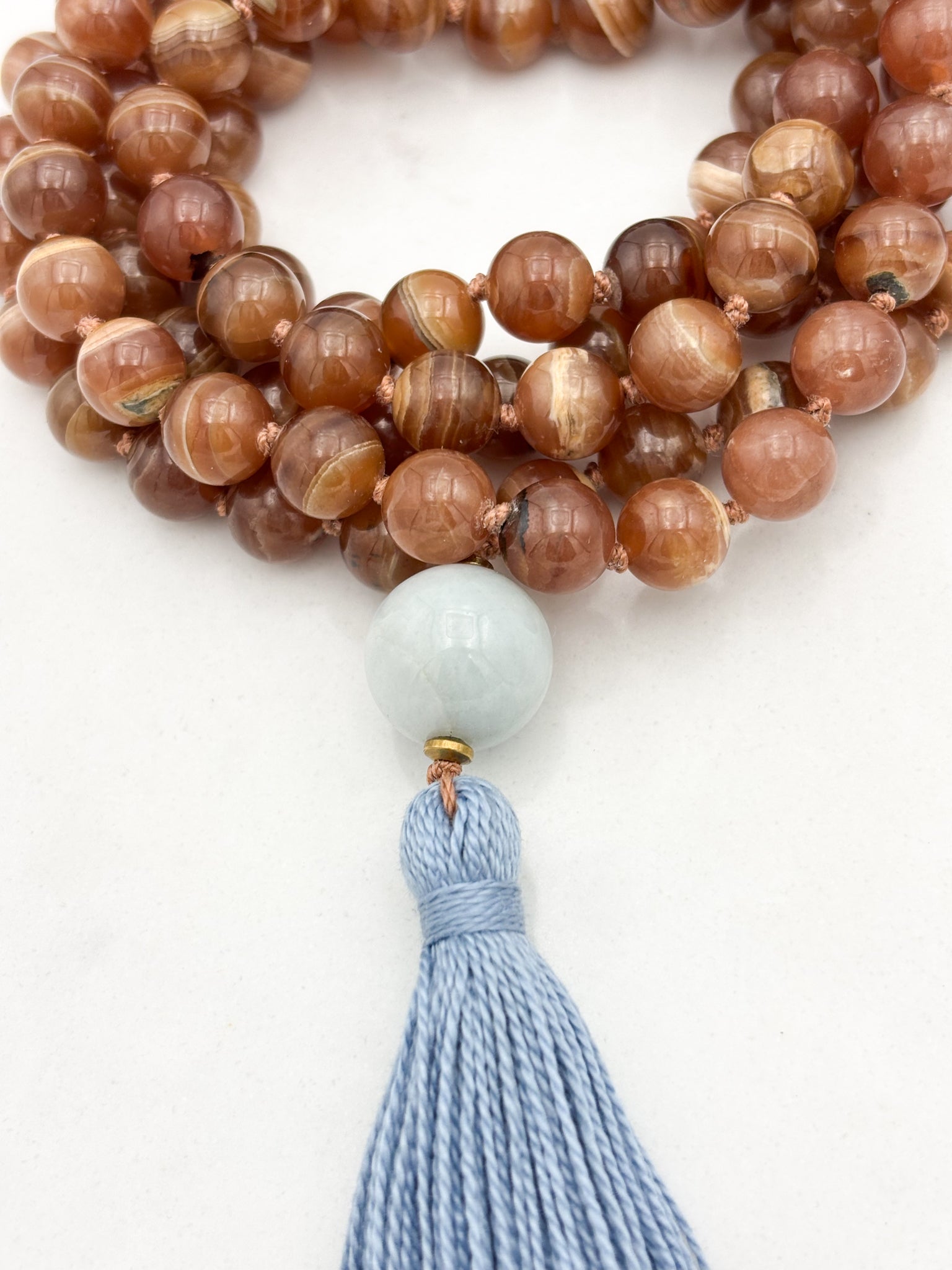 rhodochrosite gesmtone mala with burma jade guru bead and blue tassel | radiant malas | handmade in boulder, colorado