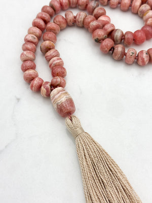rhodochrosite gemstone mala with rhodochrosite guru bead and tan tassel | radiant malas | handmade in boulder, colorado