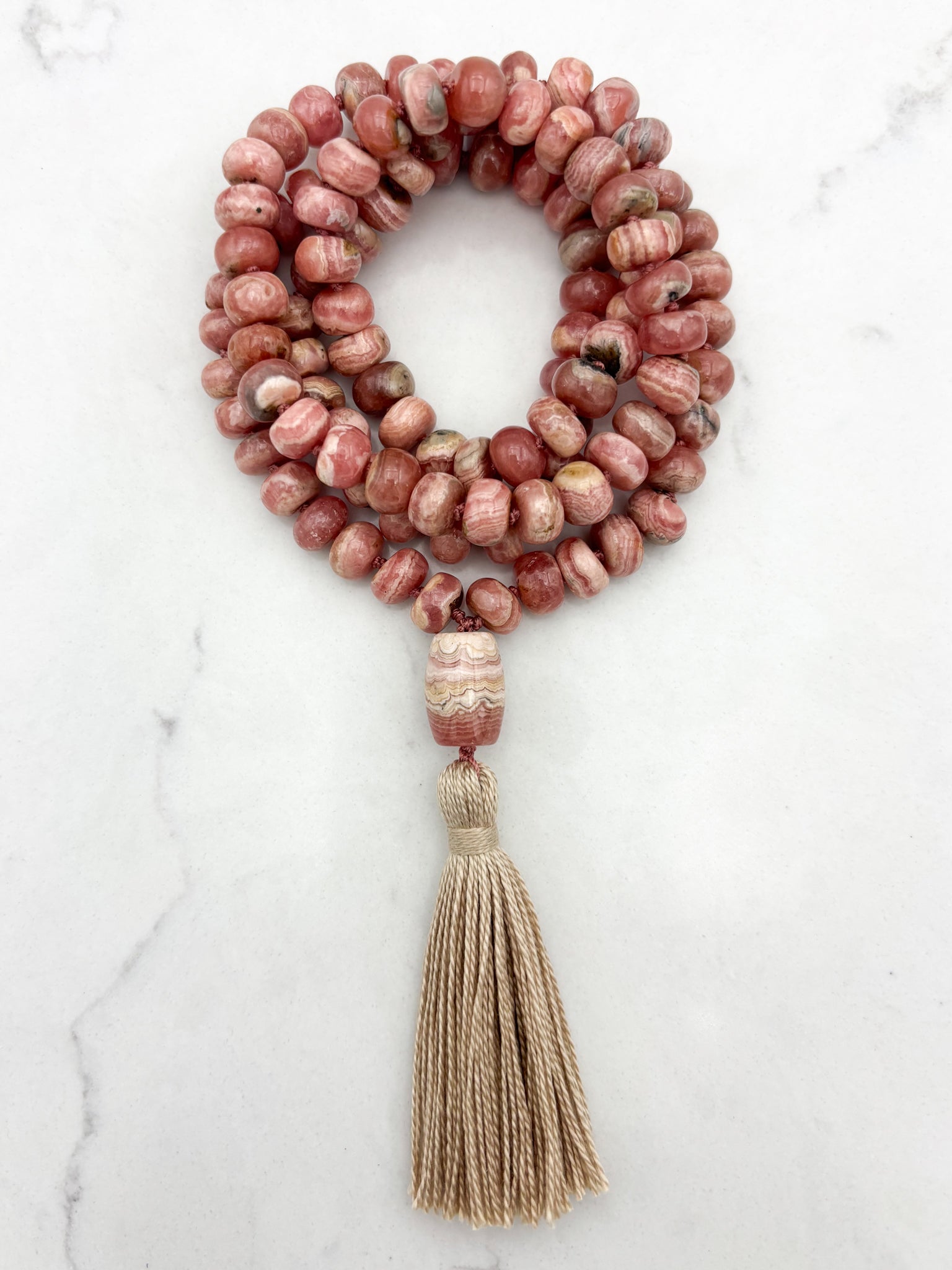 rhodochrosite gemstone mala with rhodochrosite guru bead and tan tassel | radiant malas | handmade in boulder, colorado
