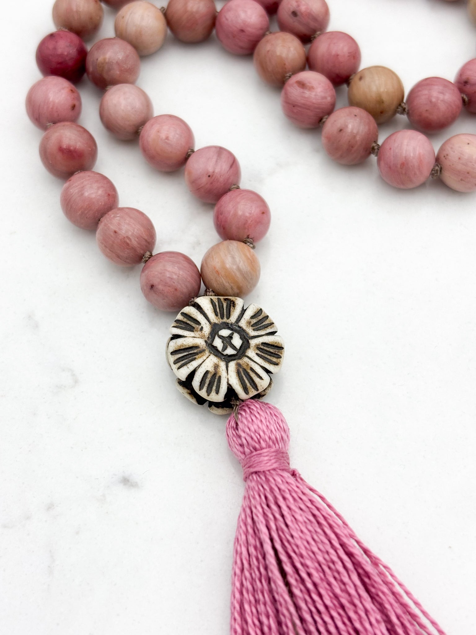 rhodonite gemstone mala with flower carved bone guru bead and pink tassel | radiant malas | handmade in boulder, colorado