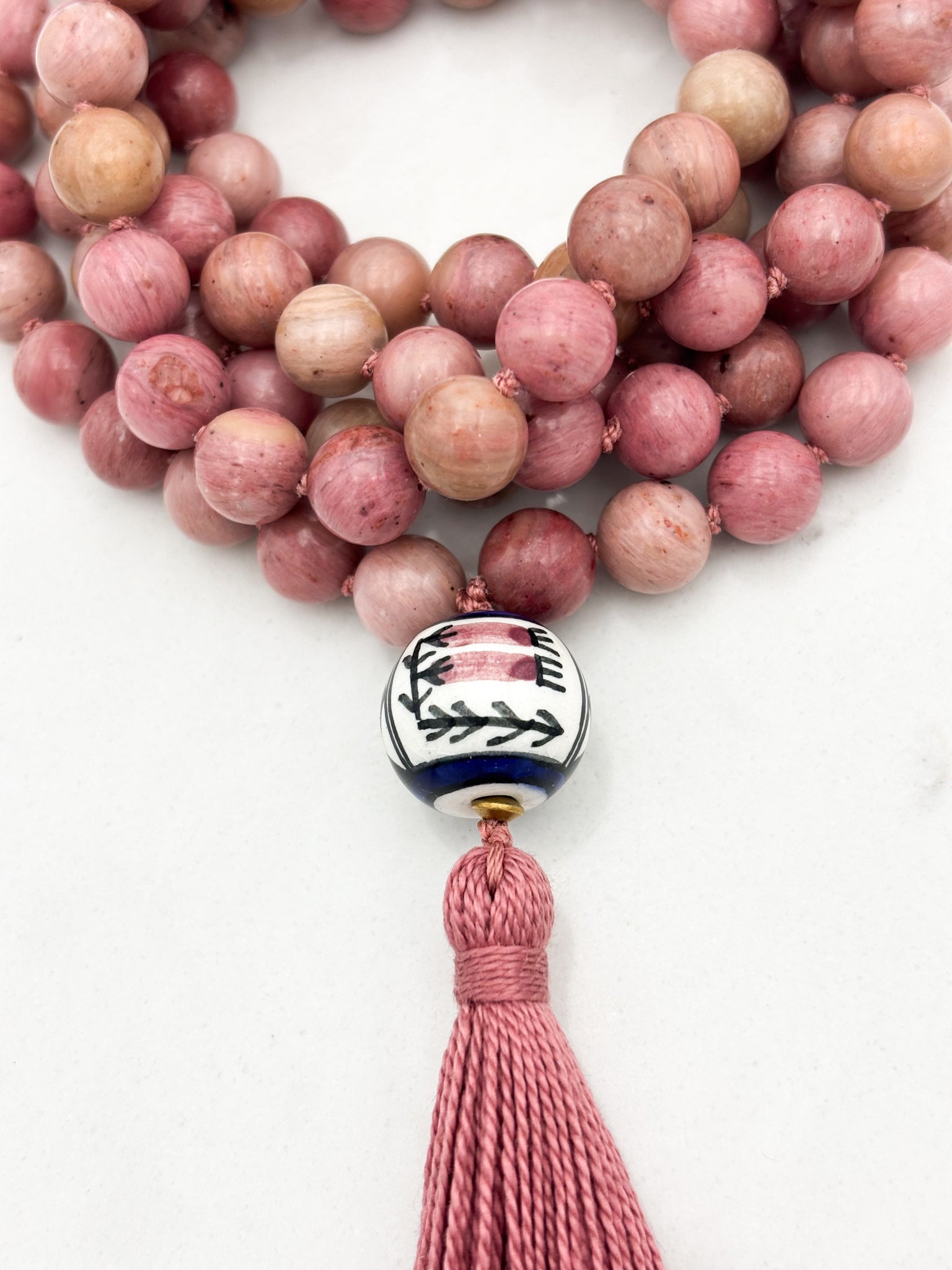 rhodonite gemstone mala with painted ceramic guru bead and pink tassel | radiant malas | handmade in boulder, colorado