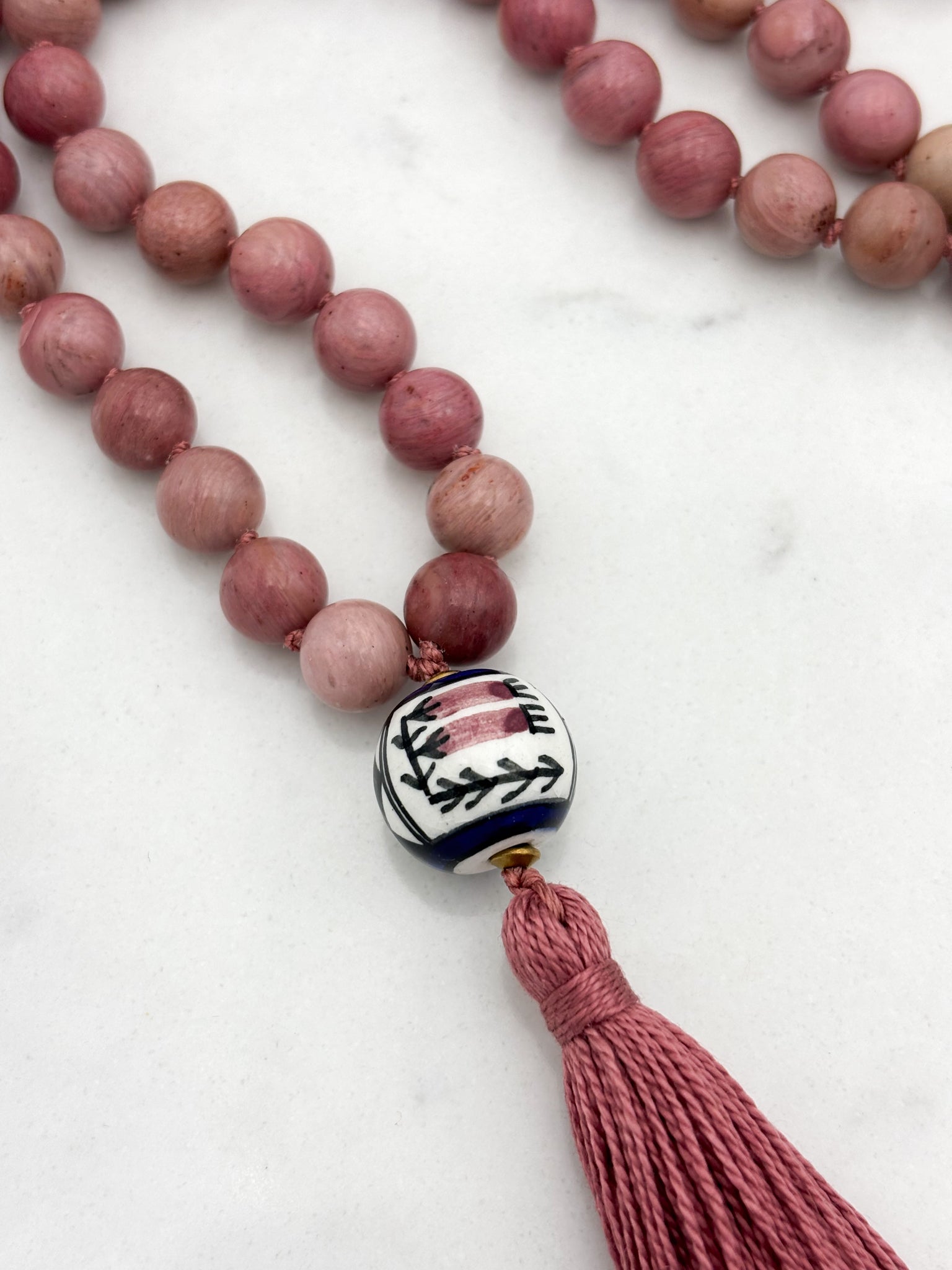 rhodonite gemstone mala with painted ceramic guru bead and pink tassel | radiant malas | handmade in boulder, colorado