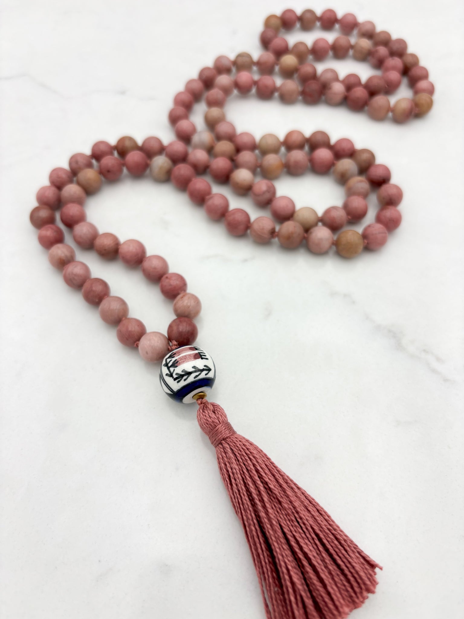 rhodonite gemstone mala with painted ceramic guru bead and pink tassel | radiant malas | handmade in boulder, colorado