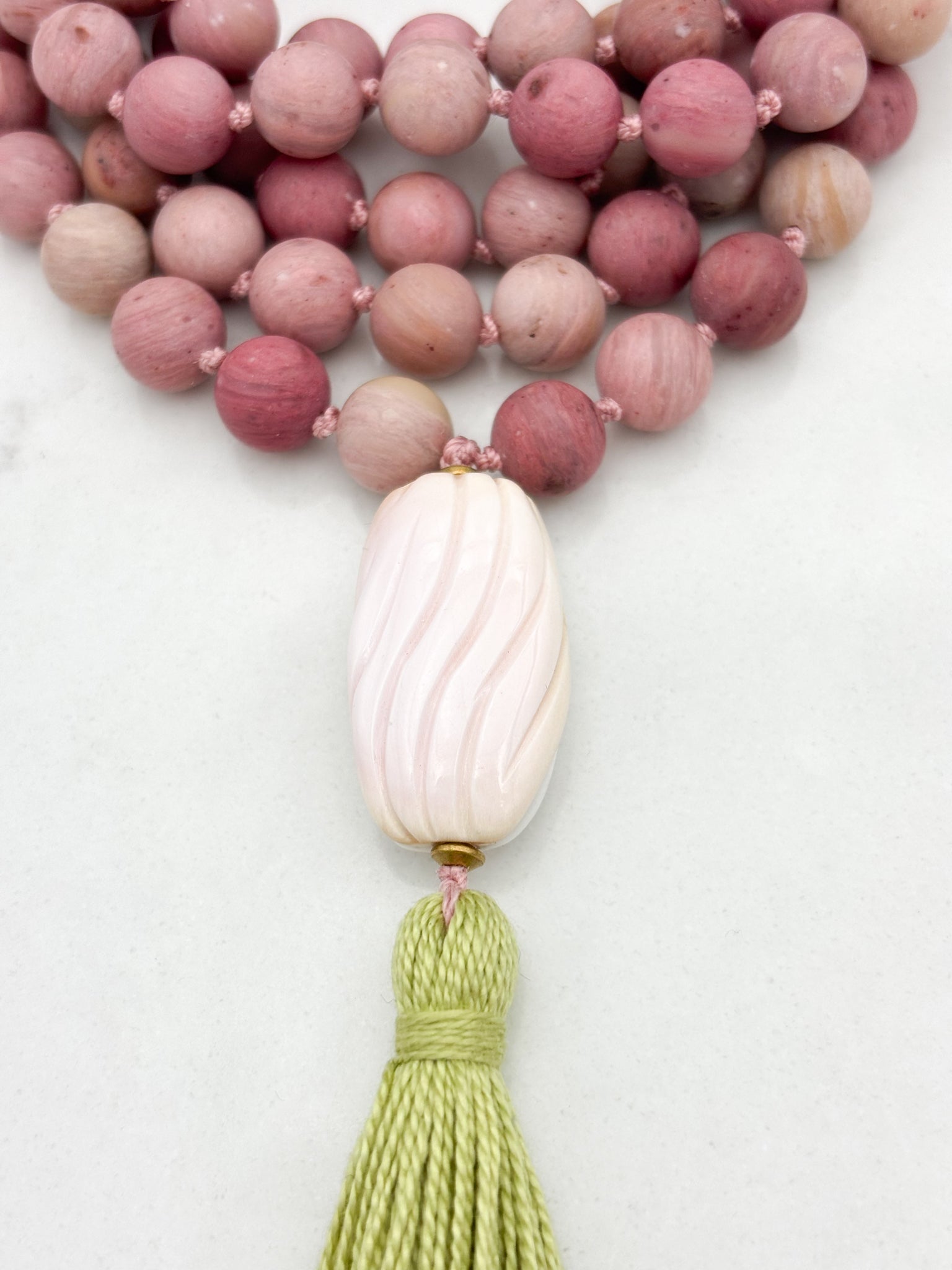 rhodonite gemstone mala with shell guru bead and green tassel | radiant malas | handmade in boulder, colorado