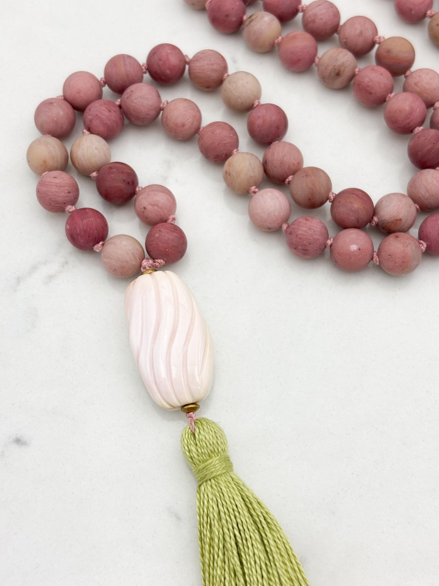 rhodonite gemstone mala with shell guru bead and green tassel | radiant malas | handmade in boulder, colorado