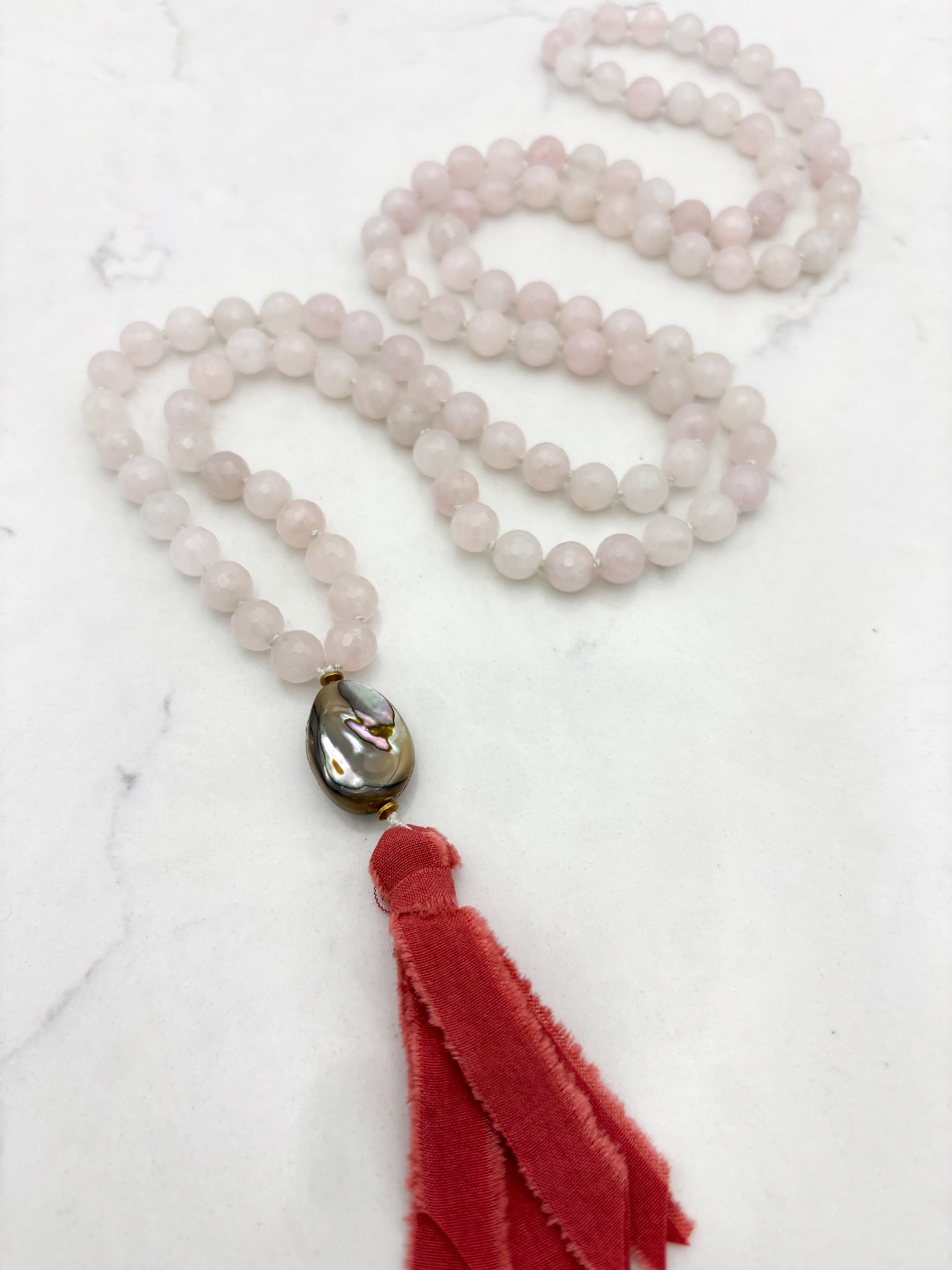 Gemstone necklace with rose quartz beads and a red silk tassel | radiant malas | handmade in boulder, colorado