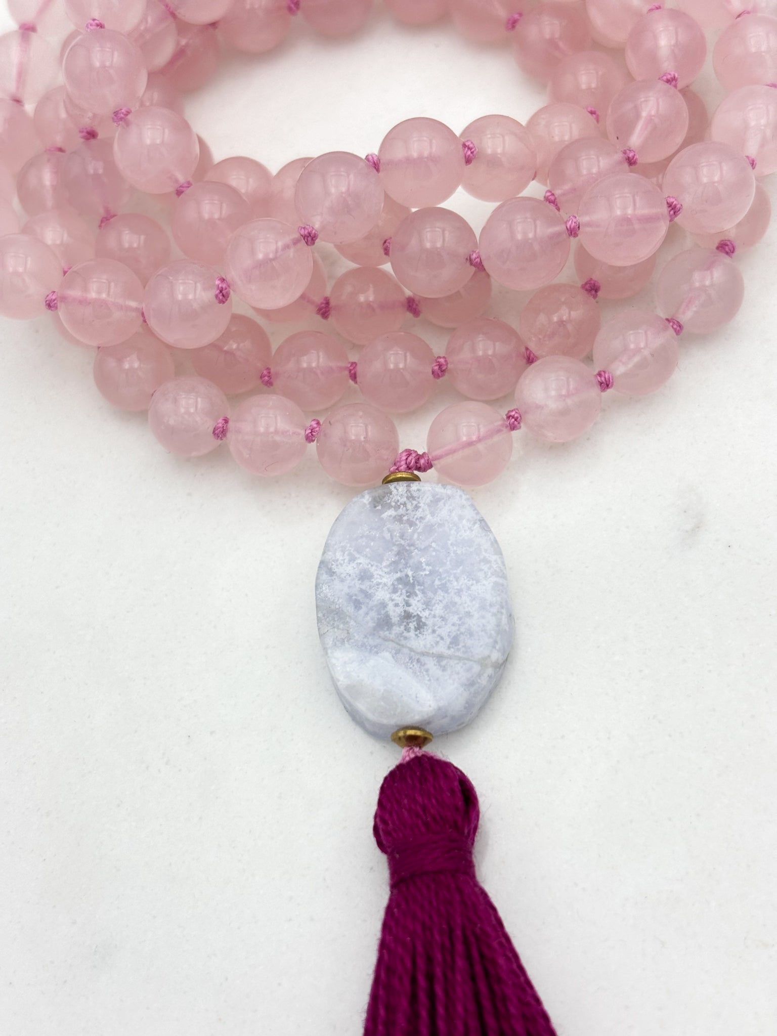 rose quartz gemstone mala necklace with blue lace agate guru bead and dark pink tassel | radiant malas | handmade in boulder, colorado