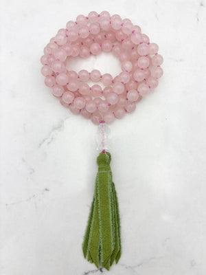 rose quartz gemstone mala with clear quartz carved koi guru bead and green silk ribbon tasssel | radiant malas | handmade in boulder, colorado