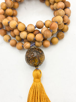 Sandalwood mala meditation necklace with tiger's eye  guru bead, and a yellow tassel | radiant malas | handmade in boulder, colorado