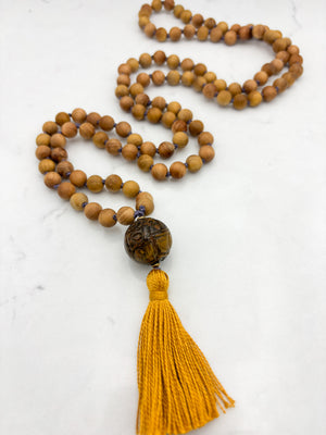 Sandalwood mala meditation necklace with tiger's eye  guru bead, and a yellow tassel | radiant malas | handmade in boulder, colorado