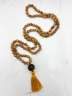 Sandalwood mala meditation necklace with tiger's eye  guru bead, and a yellow tassel | radiant malas | handmade in boulder, colorado