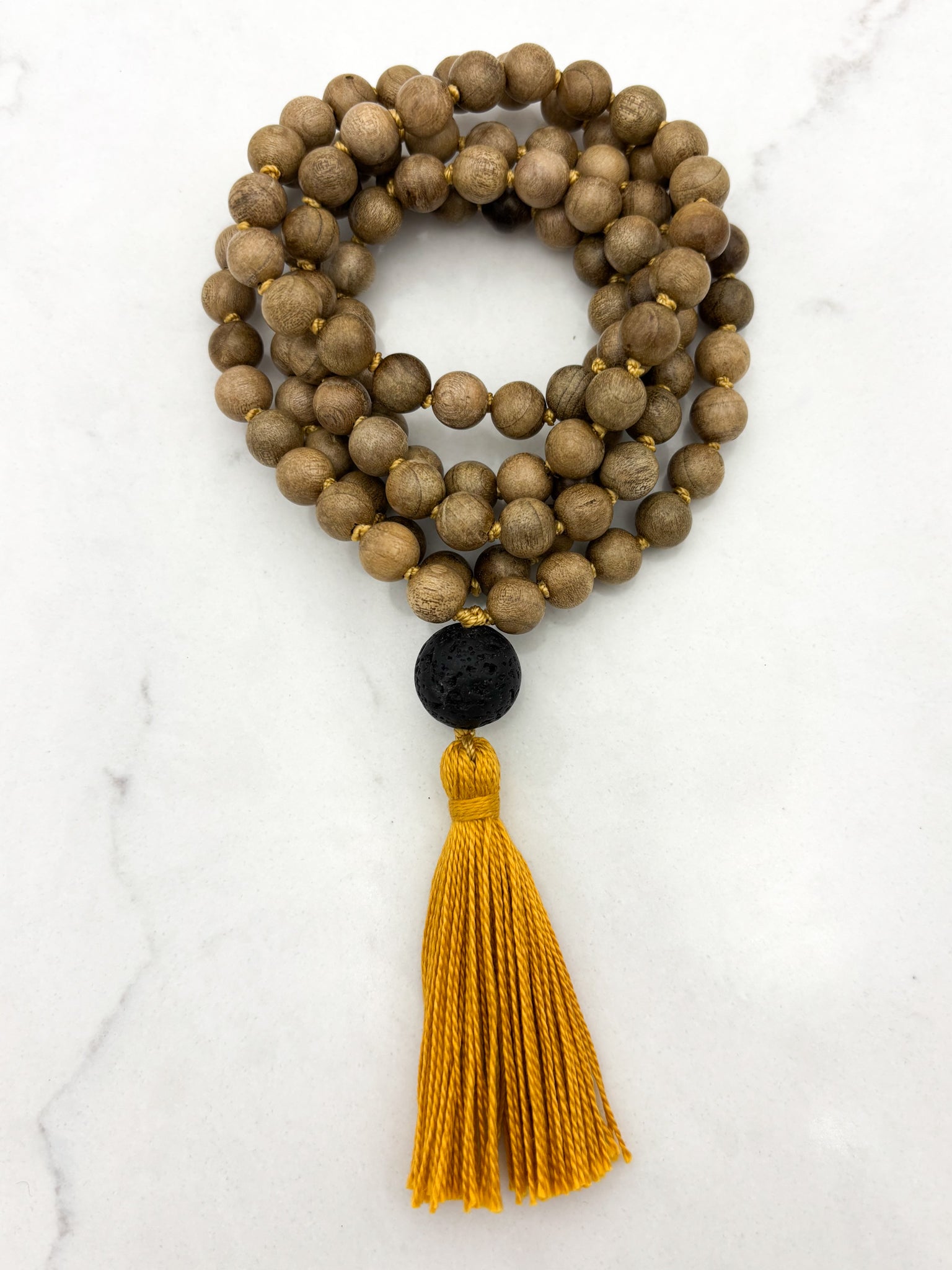 Meditation necklace with wooden beads, a black guru bead, and a yellow tassel | radiant malas | handmade in boulder, colorado