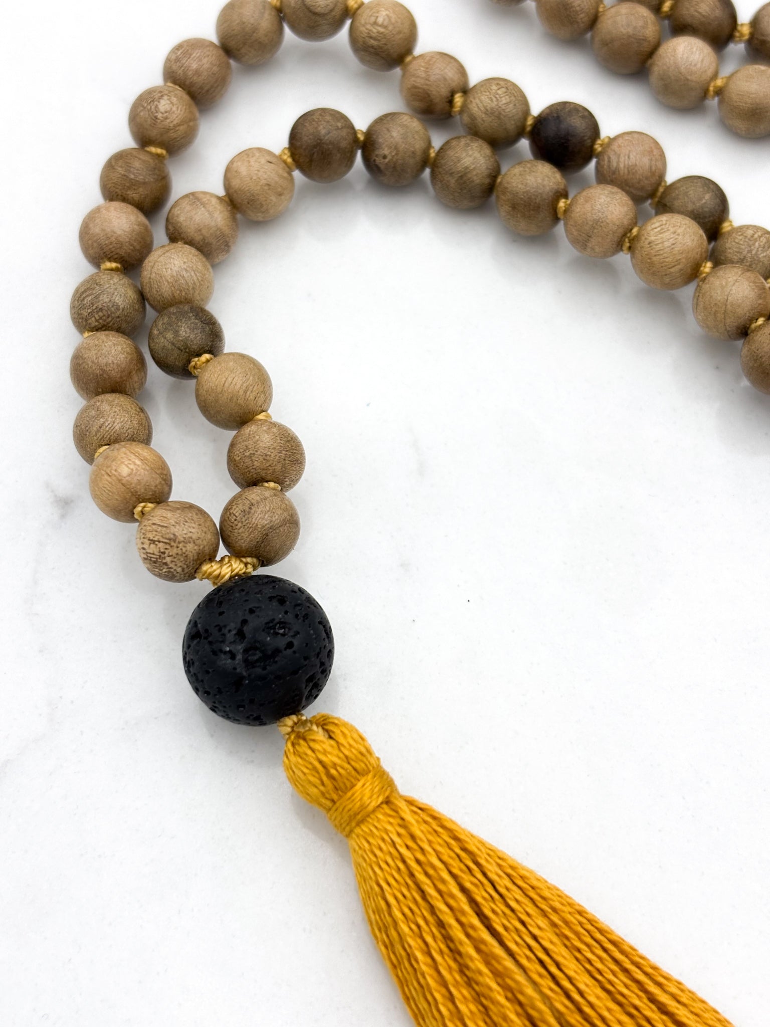 Meditation necklace with wooden beads, a black guru bead, and a yellow tassel | radiant malas | handmade in boulder, colorado