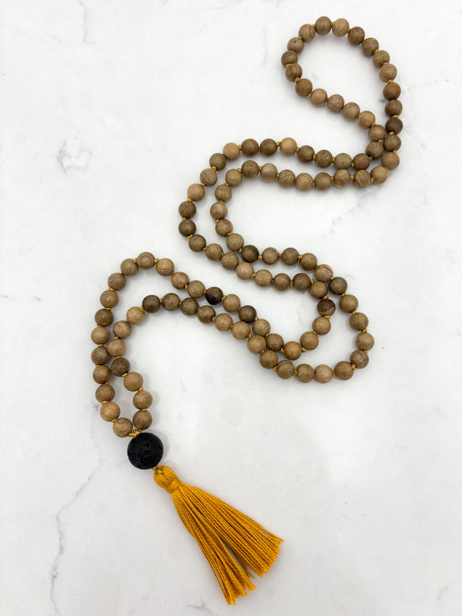 Meditation necklace with wooden beads, a black guru bead, and a yellow tassel | radiant malas | handmade in boulder, colorado