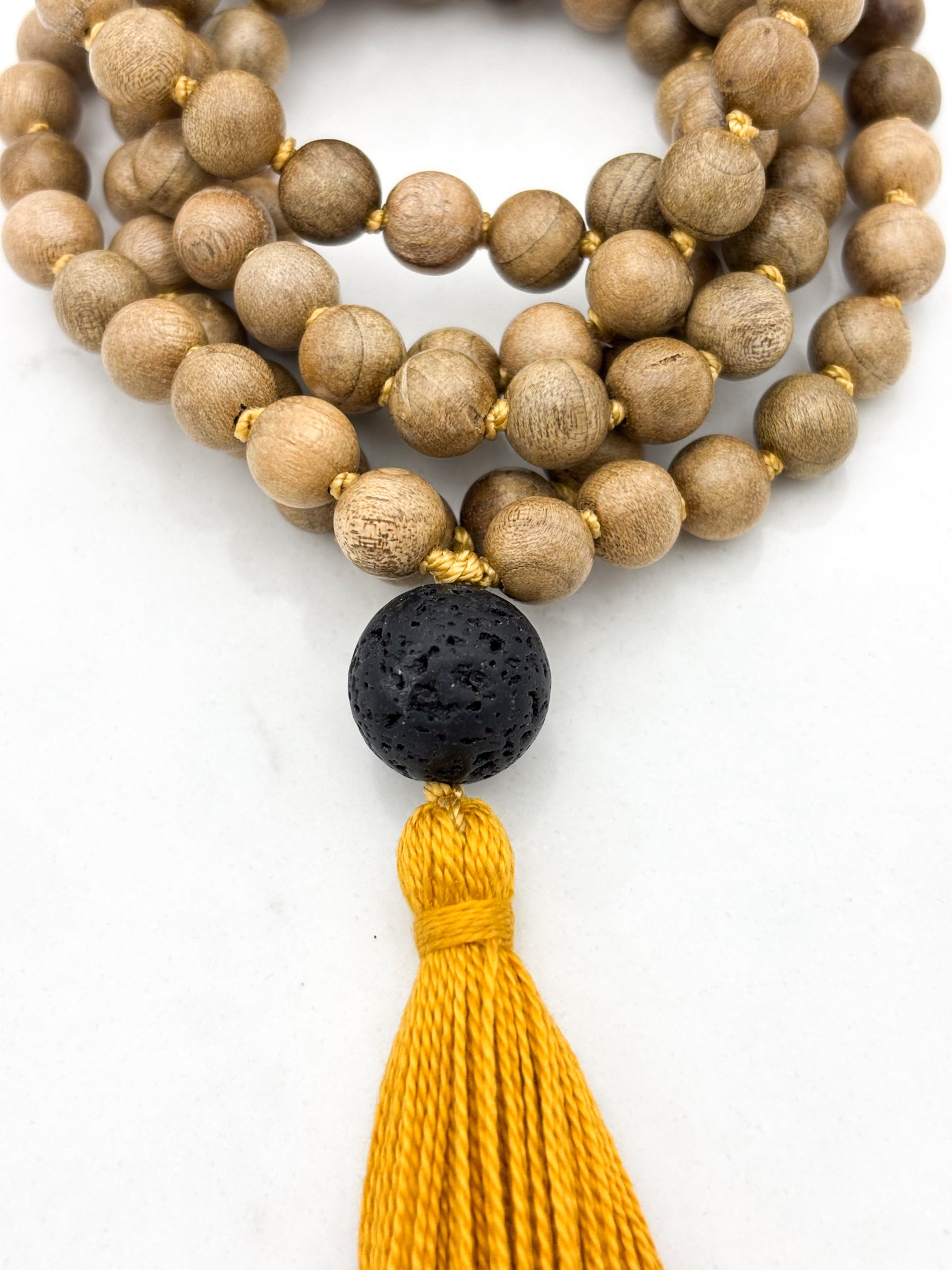 Meditation necklace with wooden beads, a black guru bead, and a yellow tassel | radiant malas | handmade in boulder, colorado