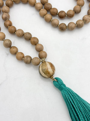 Sandalwood mala meditation necklace with wood guru bead and a green tassel | radiant malas | handmade in boulder, colorado