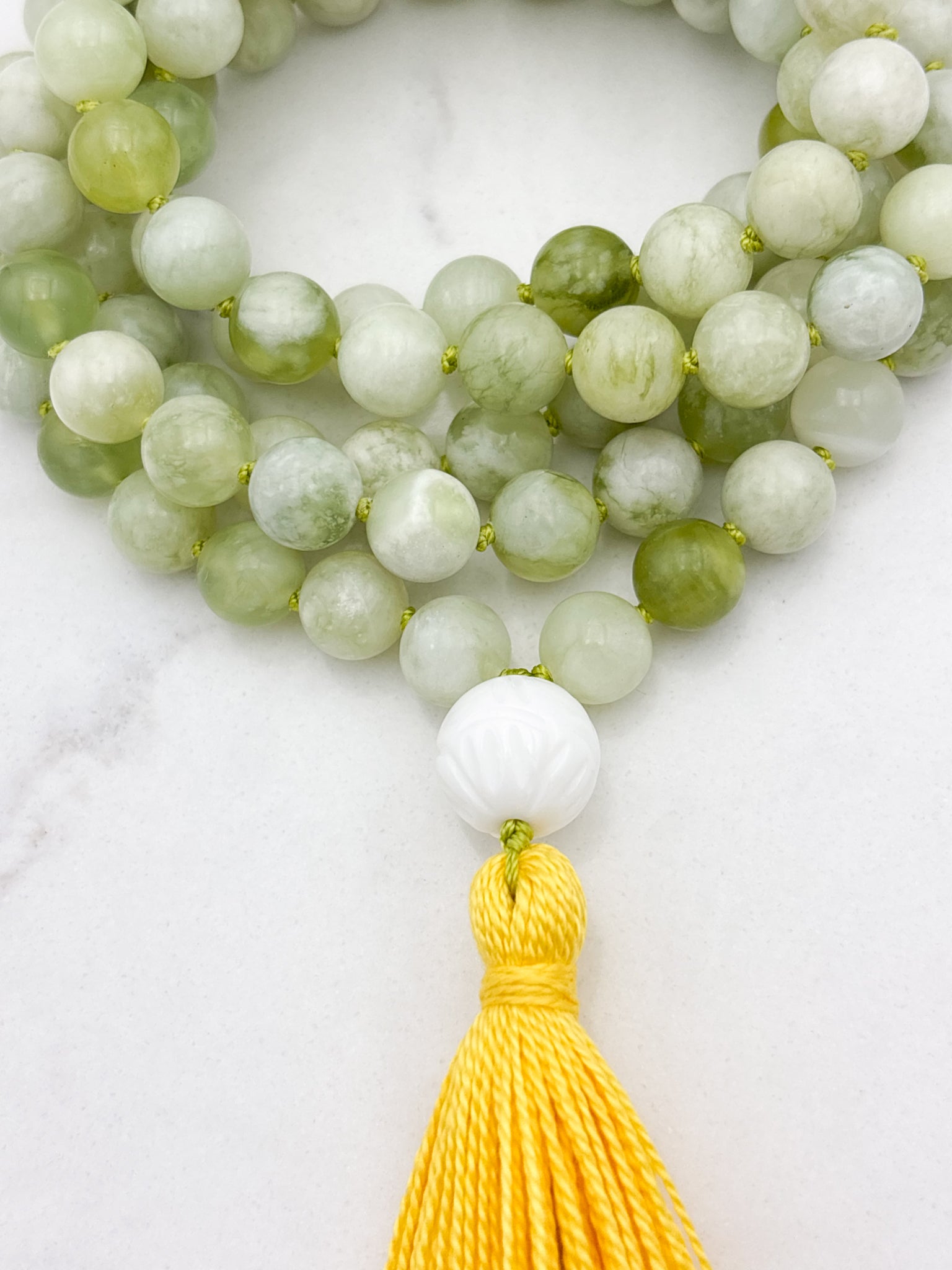 serpentine jade gemstone mala with carved white agate guru bead and yellow tassel | radiant malas | handmade in boulder, colorado