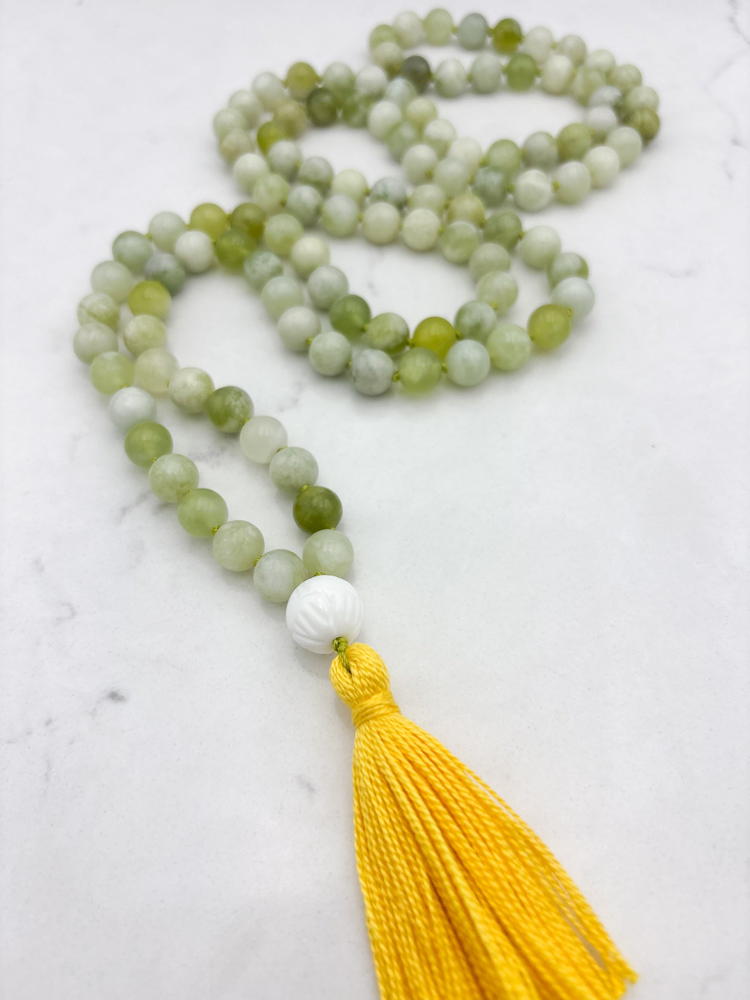 serpentine jade gemstone mala with carved white agate guru bead and yellow tassel | radiant malas | handmade in boulder, colorado