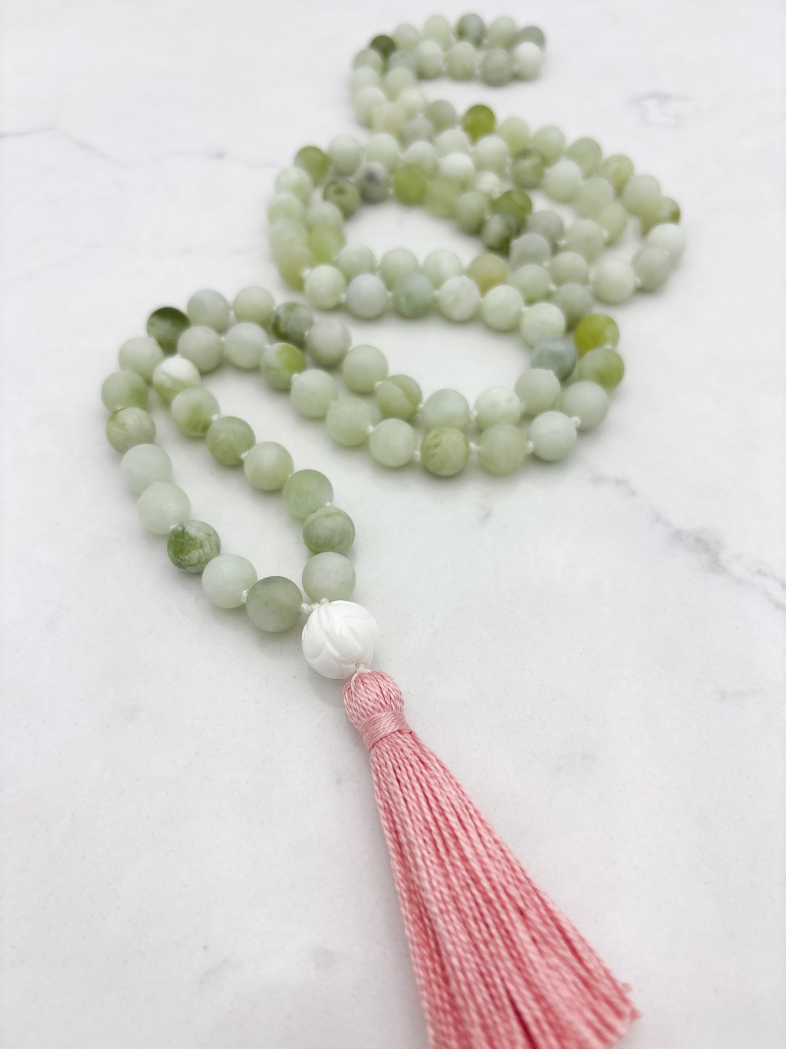 serpentine jade gemstone mala with tridacna shell guru bead and pink tassel | radiant malas  handmade in boulder, colorado