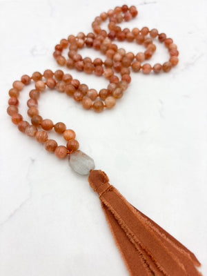 sunstone gemstone mala with aquamarine guru bead and rust silk tassel | radiant malas | handmade in boulder, colorado