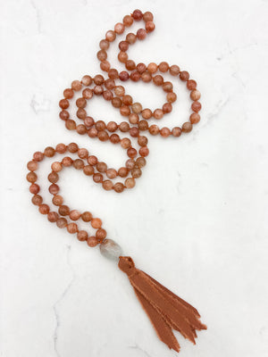 sunstone gemstone mala with aquamarine guru bead and rust silk tassel | radiant malas | handmade in boulder, colorado