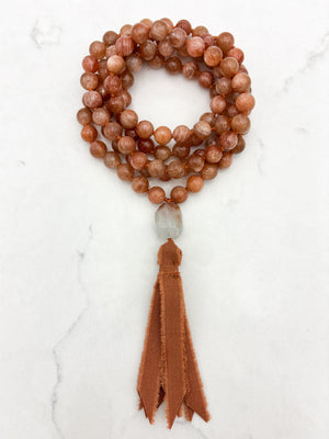 sunstone gemstone mala with aquamarine guru bead and rust silk tassel | radiant malas | handmade in boulder, colorado