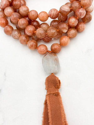 sunstone gemstone mala with aquamarine guru bead and rust silk tassel | radiant malas | handmade in boulder, colorado