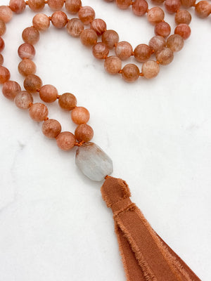 sunstone gemstone mala with aquamarine guru bead and rust silk tassel | radiant malas | handmade in boulder, colorado