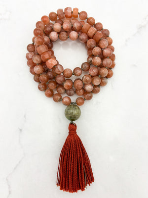 sunstone gemstone mala with cat's eye tourmaline guru bead and rust tassel | radiant malas | handmade in boulder, colorado