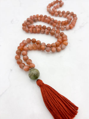 sunstone gemstone mala with cat's eye tourmaline guru bead and rust tassel | radiant malas | handmade in boulder, colorado