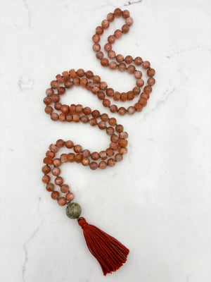 sunstone gemstone mala with cat's eye tourmaline guru bead and rust tassel | radiant malas | handmade in boulder, colorado