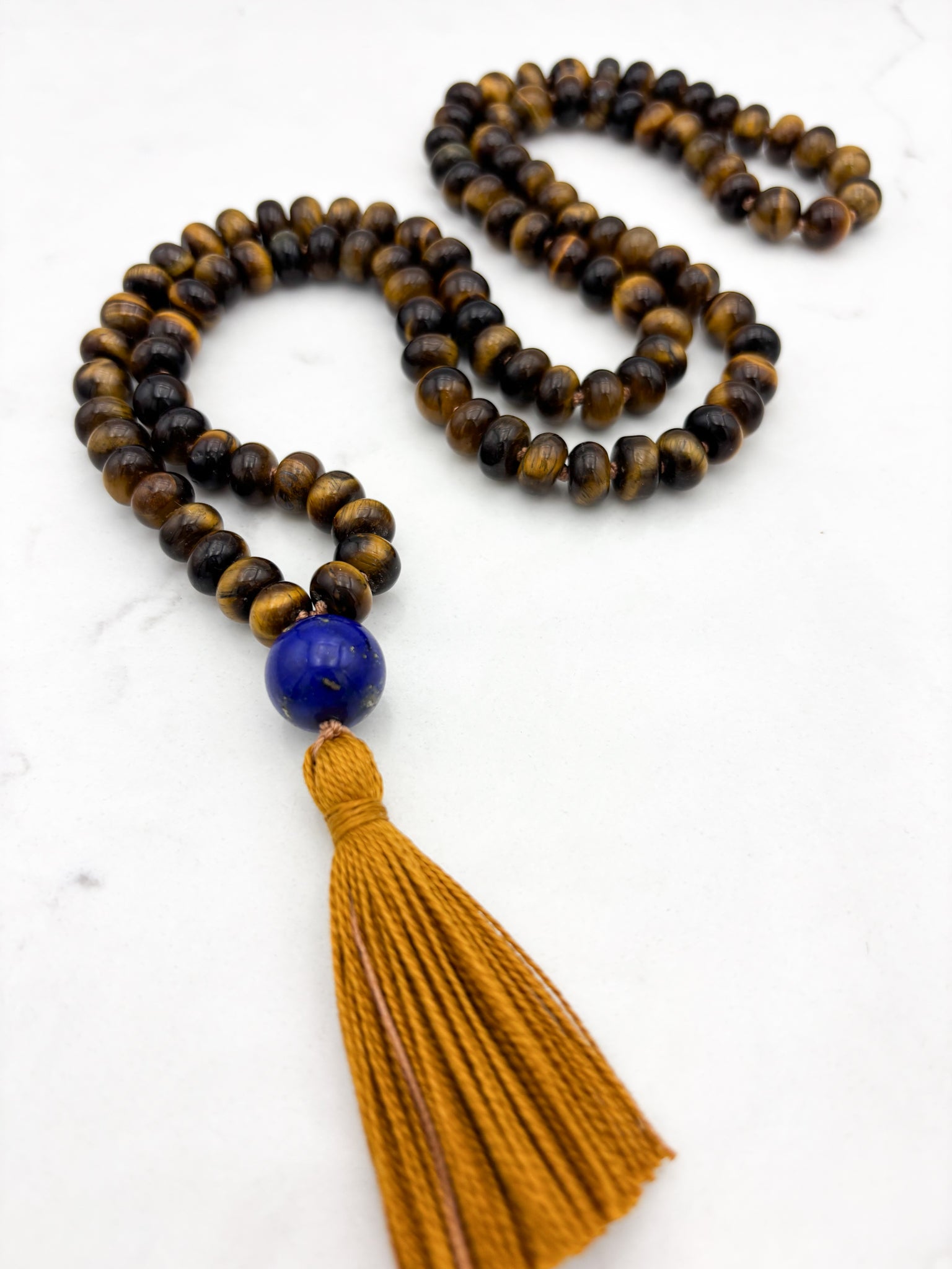 tiger's eye gemstone mala with lapis guru bead and gold tassel | radiant malas | handmade in boulder, colorado